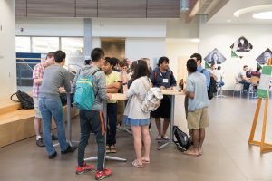 Participants in the q-bio Summer School at Colorado State University discuss their research and socialize at a poster session and reception, June 5, 2017.